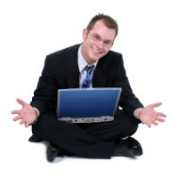 Business Man Sitting On Floor With Laptop Hands Out