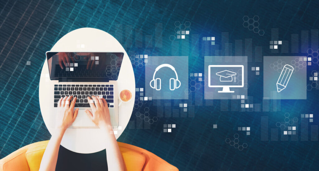 Person typing on a laptop at a round white table with a cup of coffee, overlaid with learning- and tech-icons in blue.